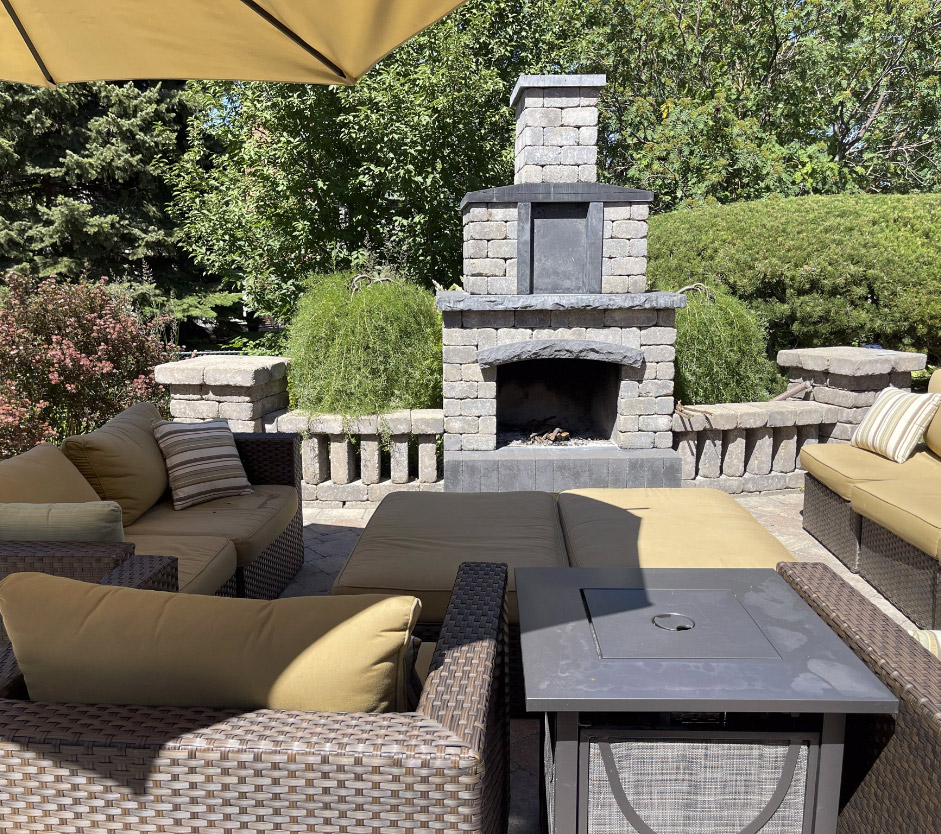 Backyard fireplace with patio furniture