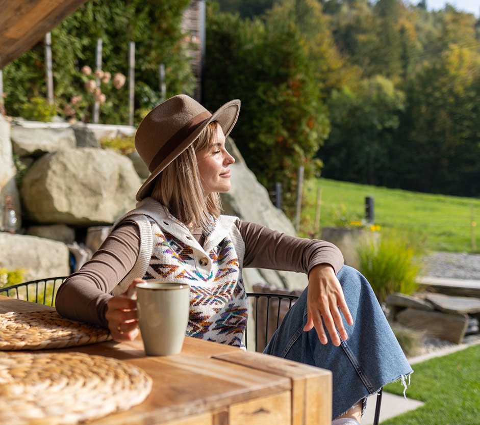 Woman relaxing in a landscaped backyard